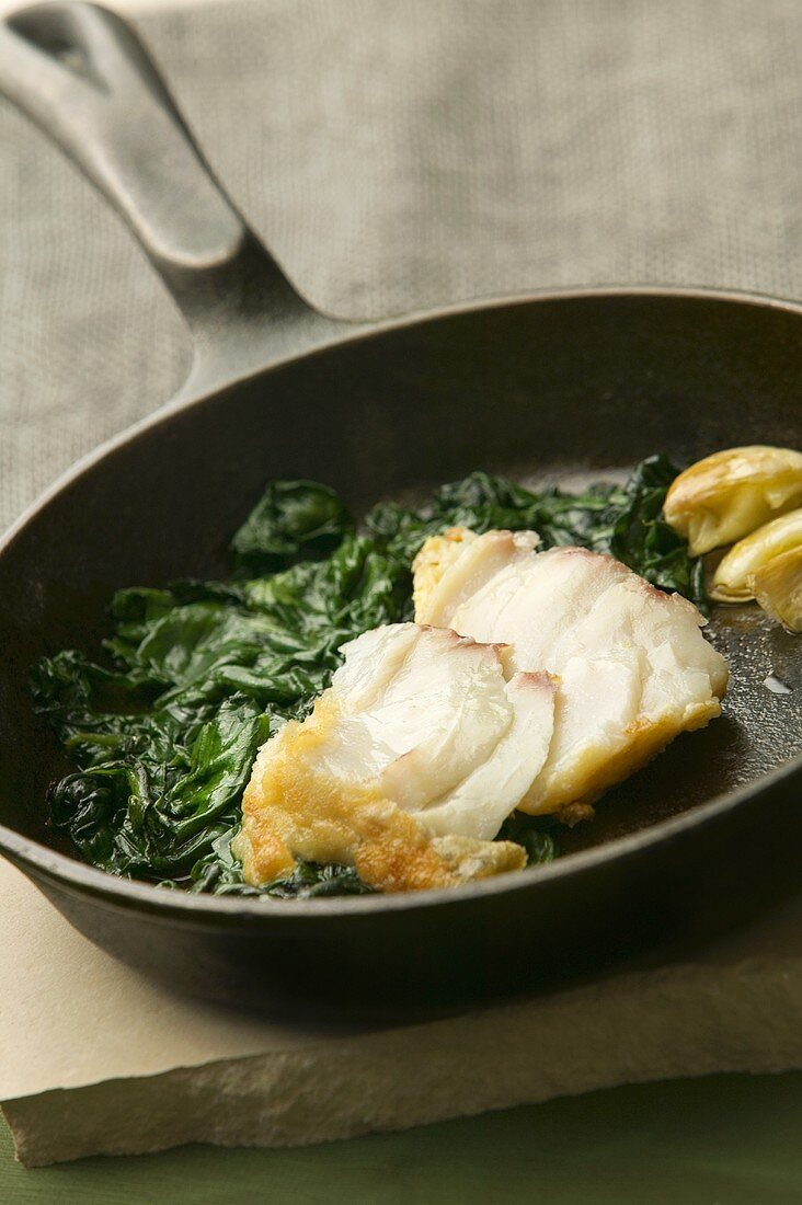 Fried cod fillet with spinach
