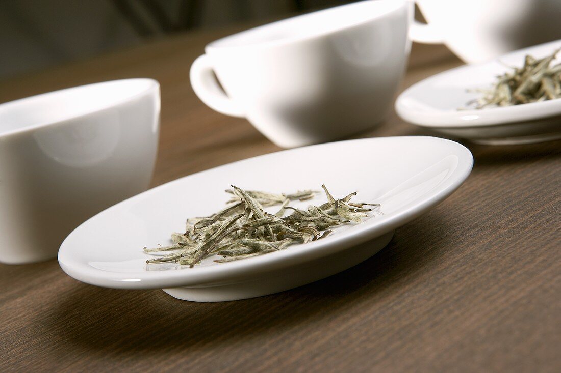 Dry herb tea and teacups