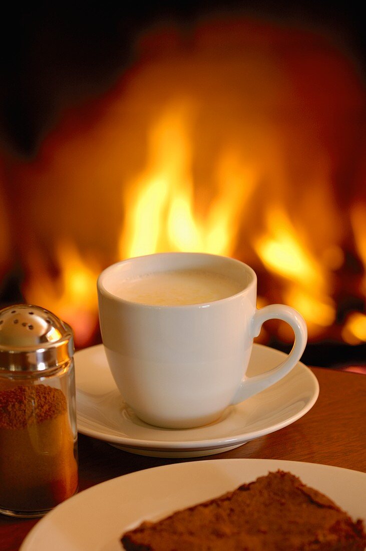 A cup of cappuccino by the fireside
