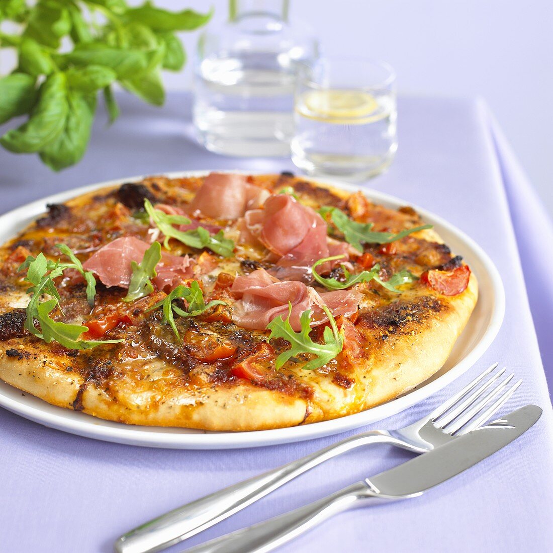 Pizza with ham and rocket
