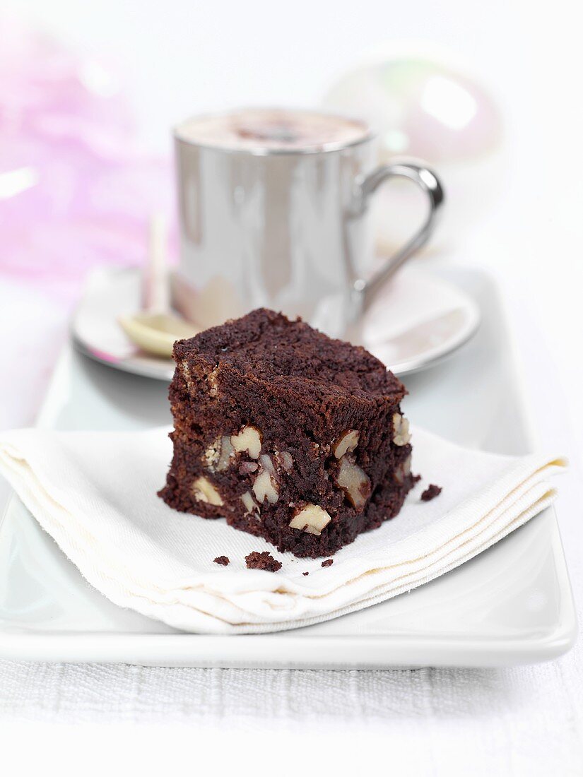 Brownie with a cup of cappuccino on a plate
