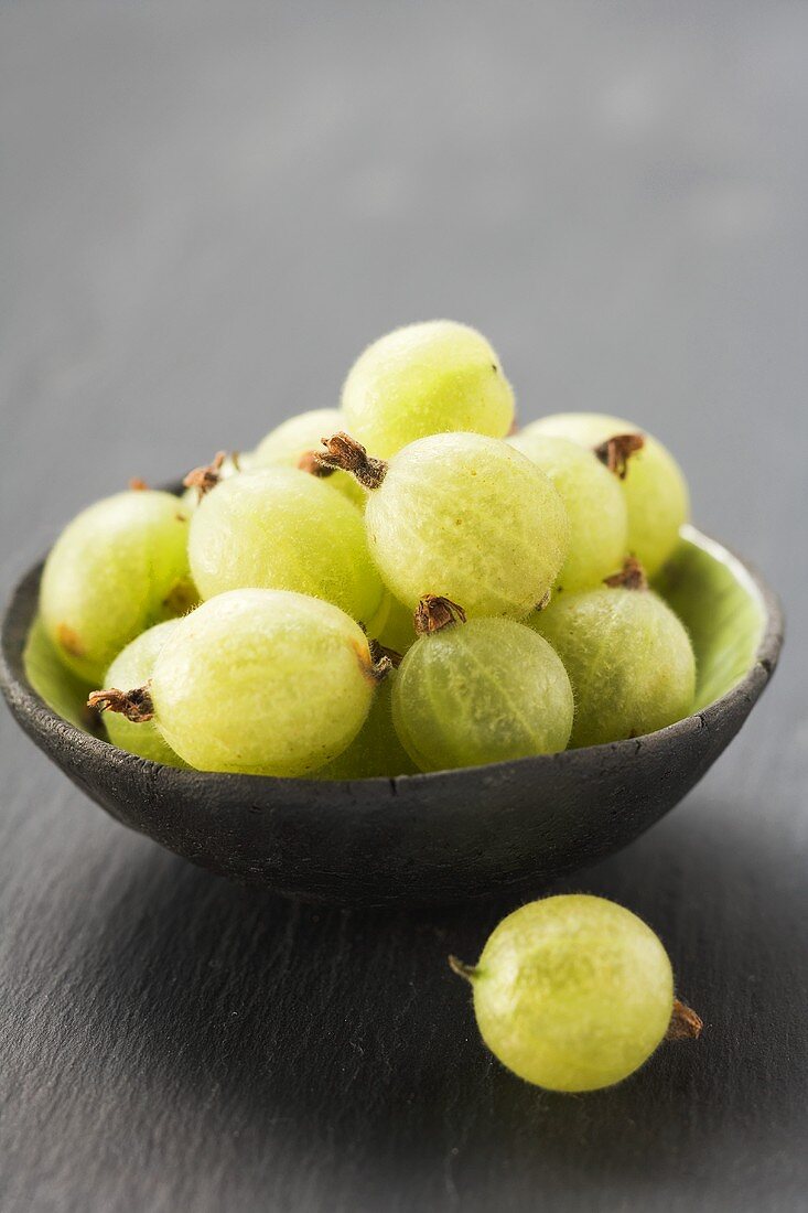 Green gooseberries in bowl