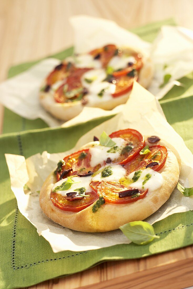 Mini-pizzas with tomato and mozzarella topping