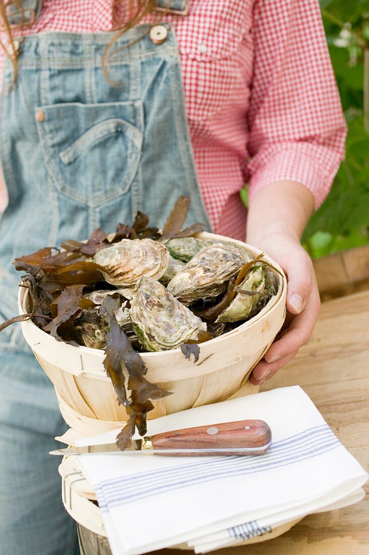 Woman with basket full of oysters