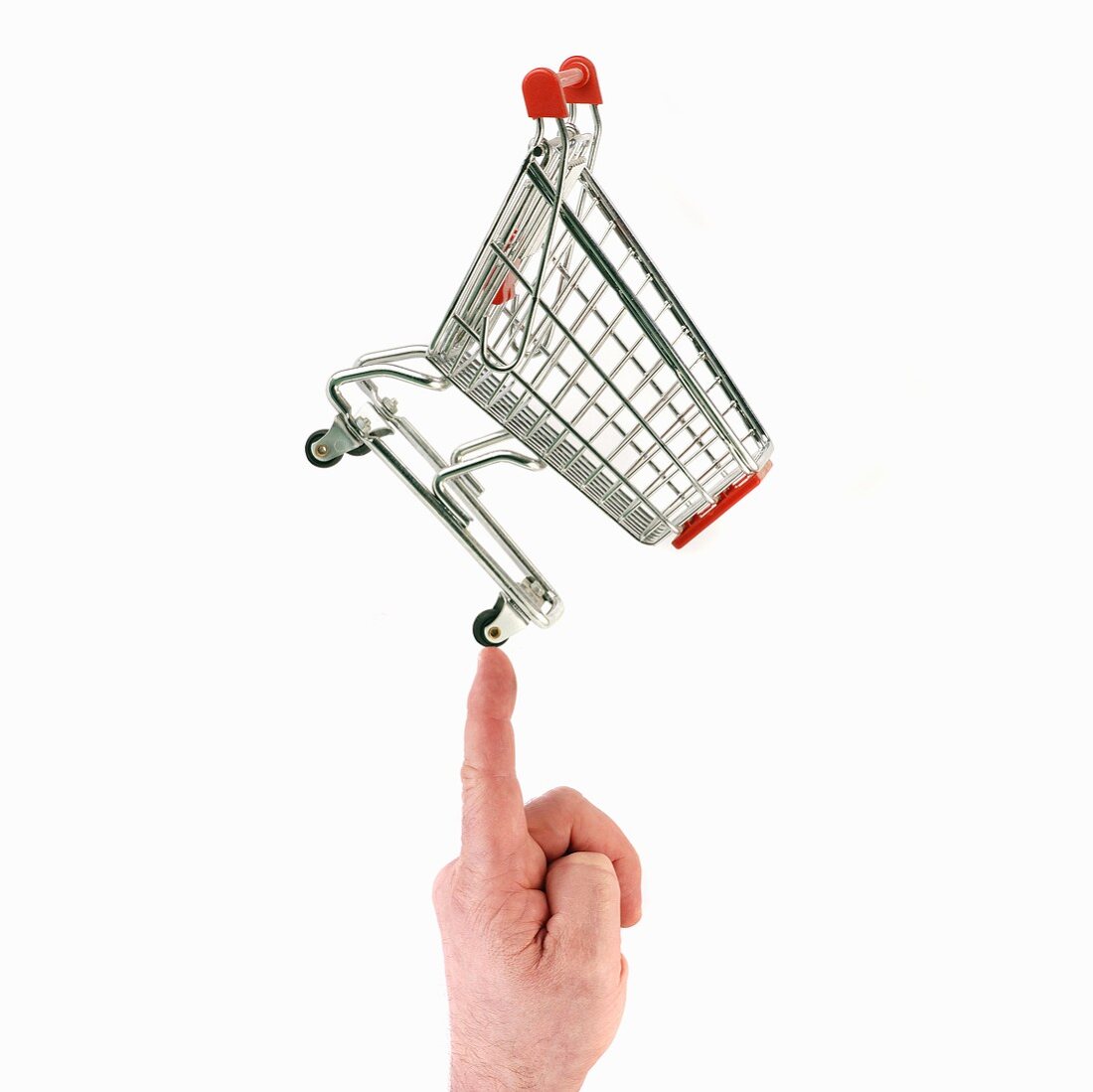Shopping trolley on the tip of someone's finger