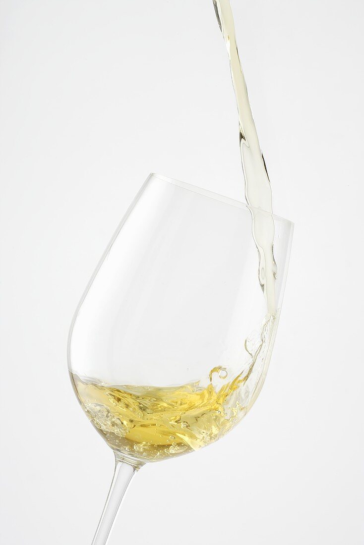 Pouring white wine into a glass