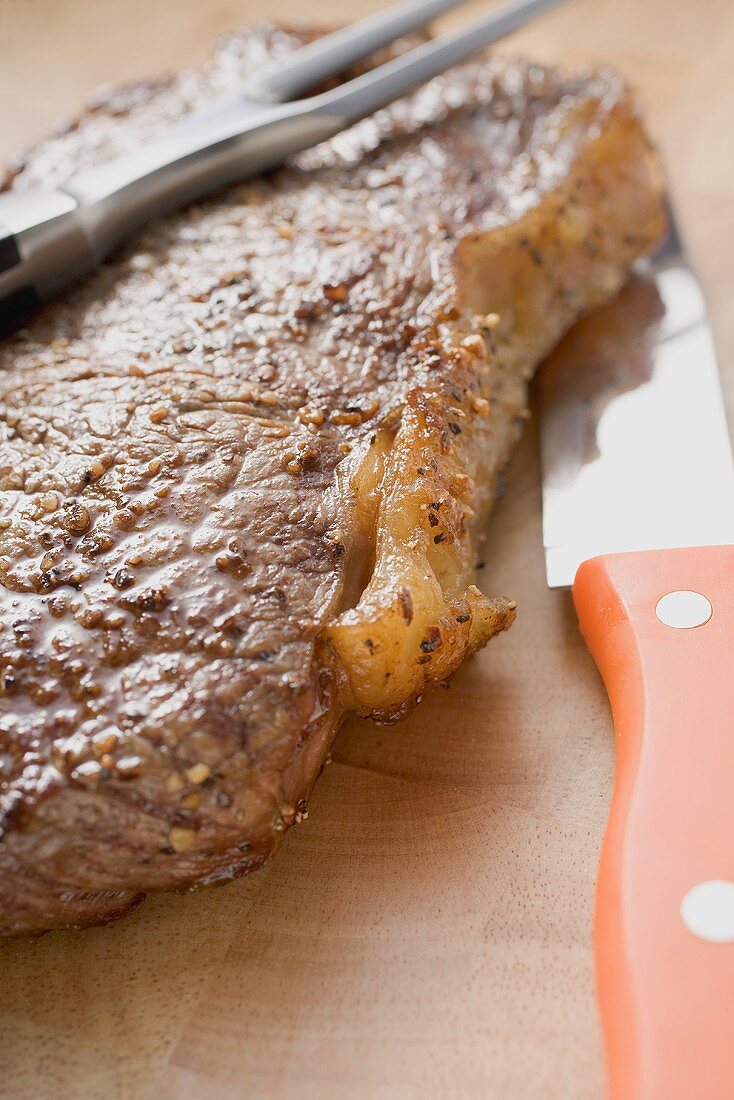 Beef steak with carving fork and knife