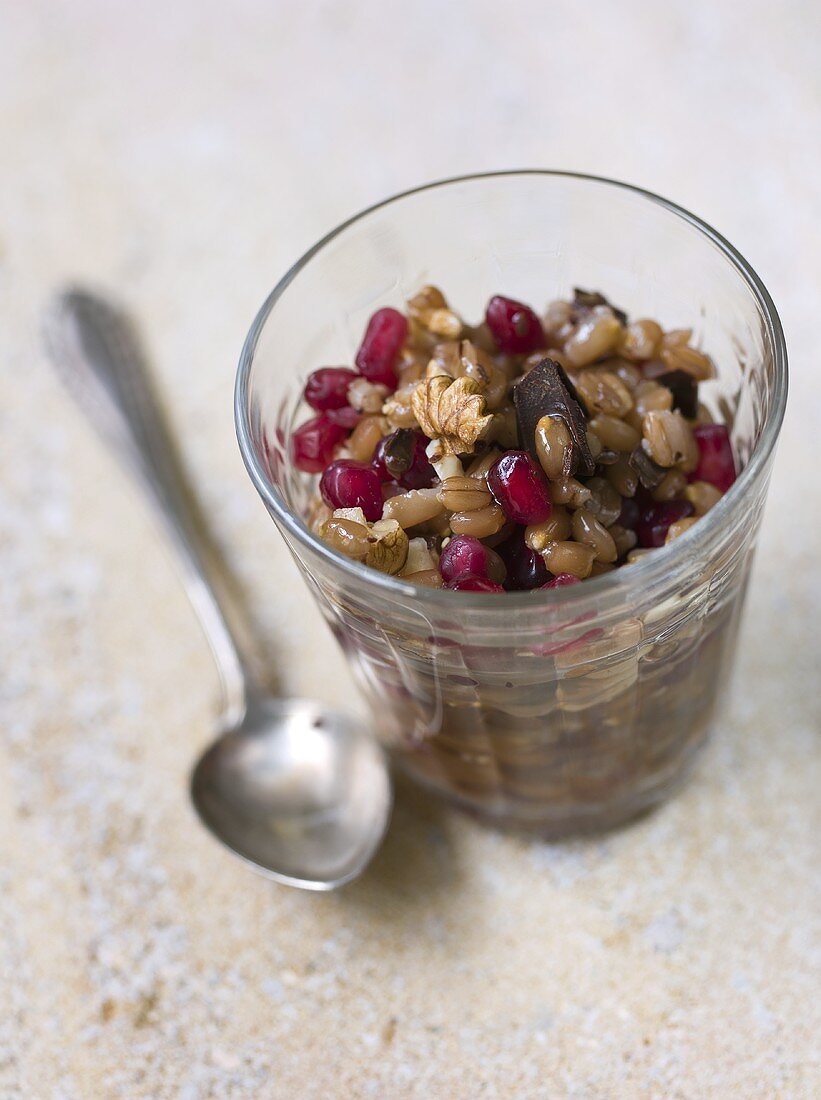 Muesli with nuts and pomegranate seeds in a glass