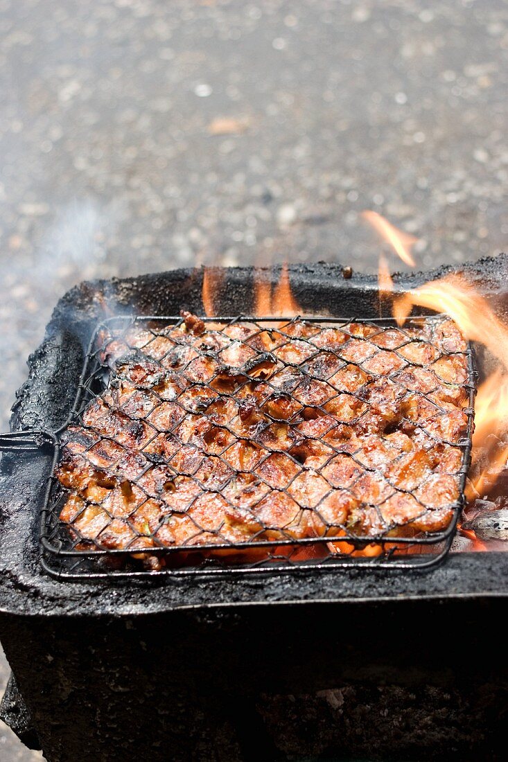 Chicken on a charcoal barbecue out of doors