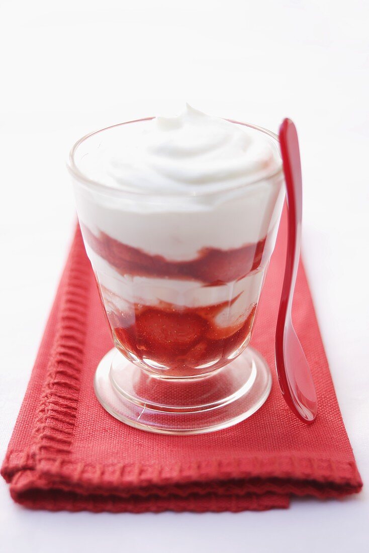 Quark and strawberres in glass on fabric napkin