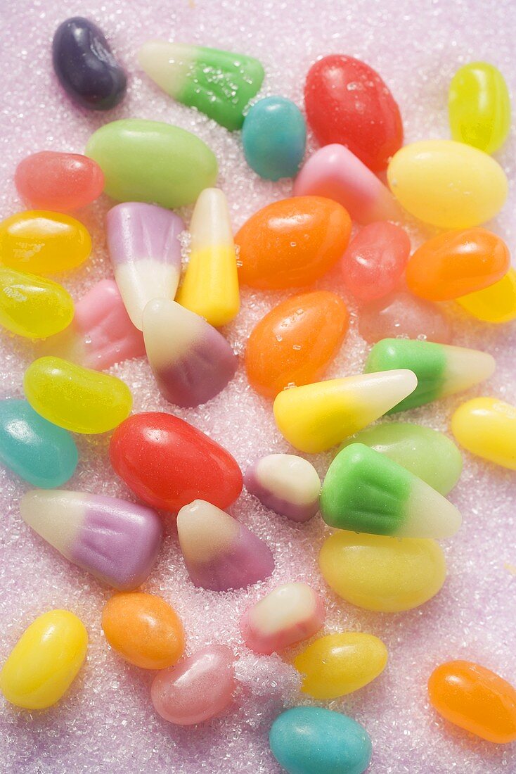 Coloured jelly beans and candy corn on sugar