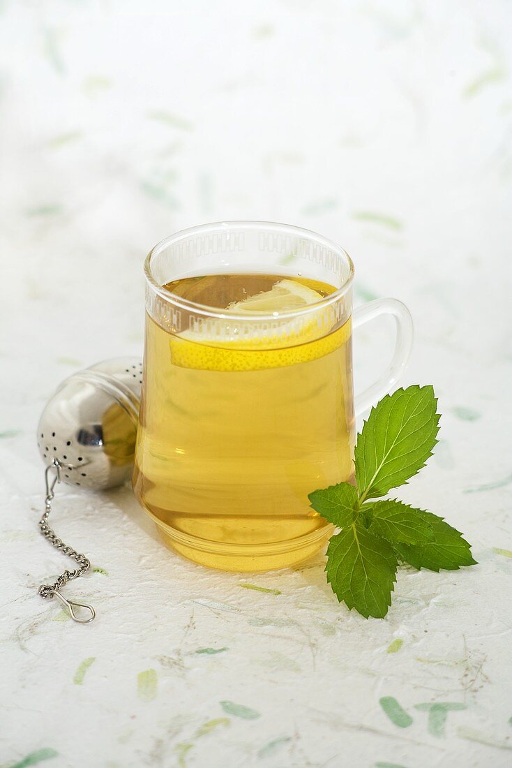A glass of mint tea with lemon