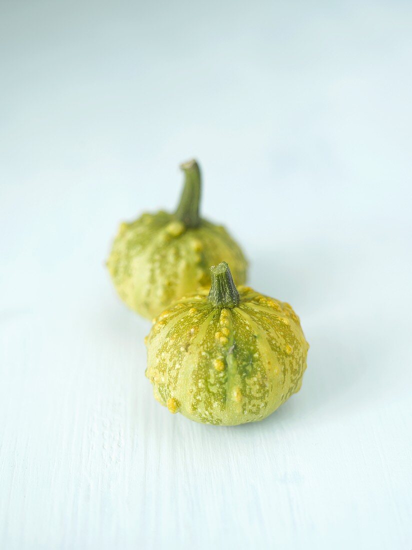 Two green ornamental gourds