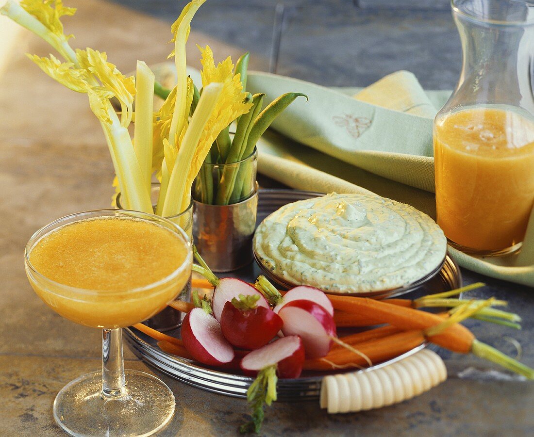 Raw vegetables with herb dip and vegetable juice