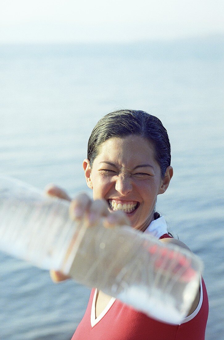 Ambitious young woman holding up a bottle