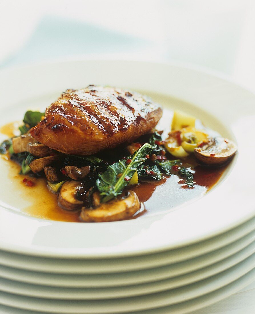Honey-glazed chicken breast on spinach and mushrooms