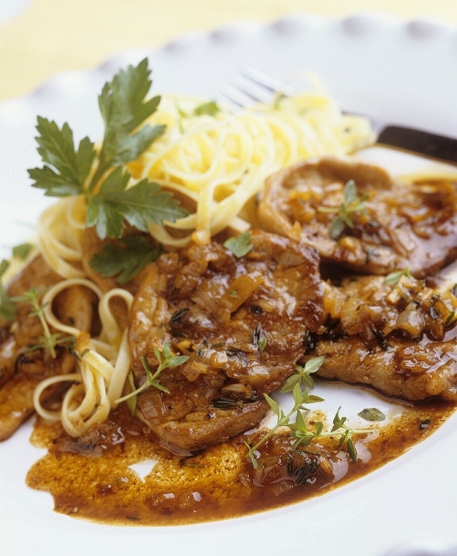 Veal escalopes with onions and ribbon pasta