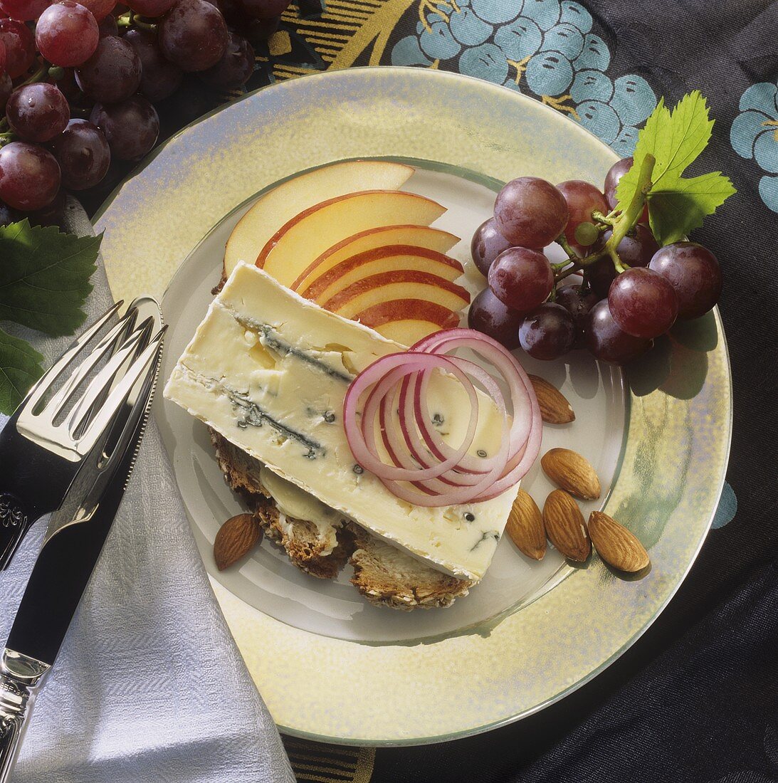 Bread and cheese with grapes and almonds