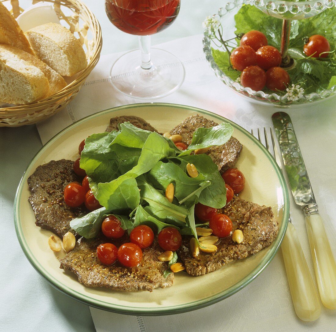 Beef fillets with peanuts, cocktail tomatoes & salad leaves