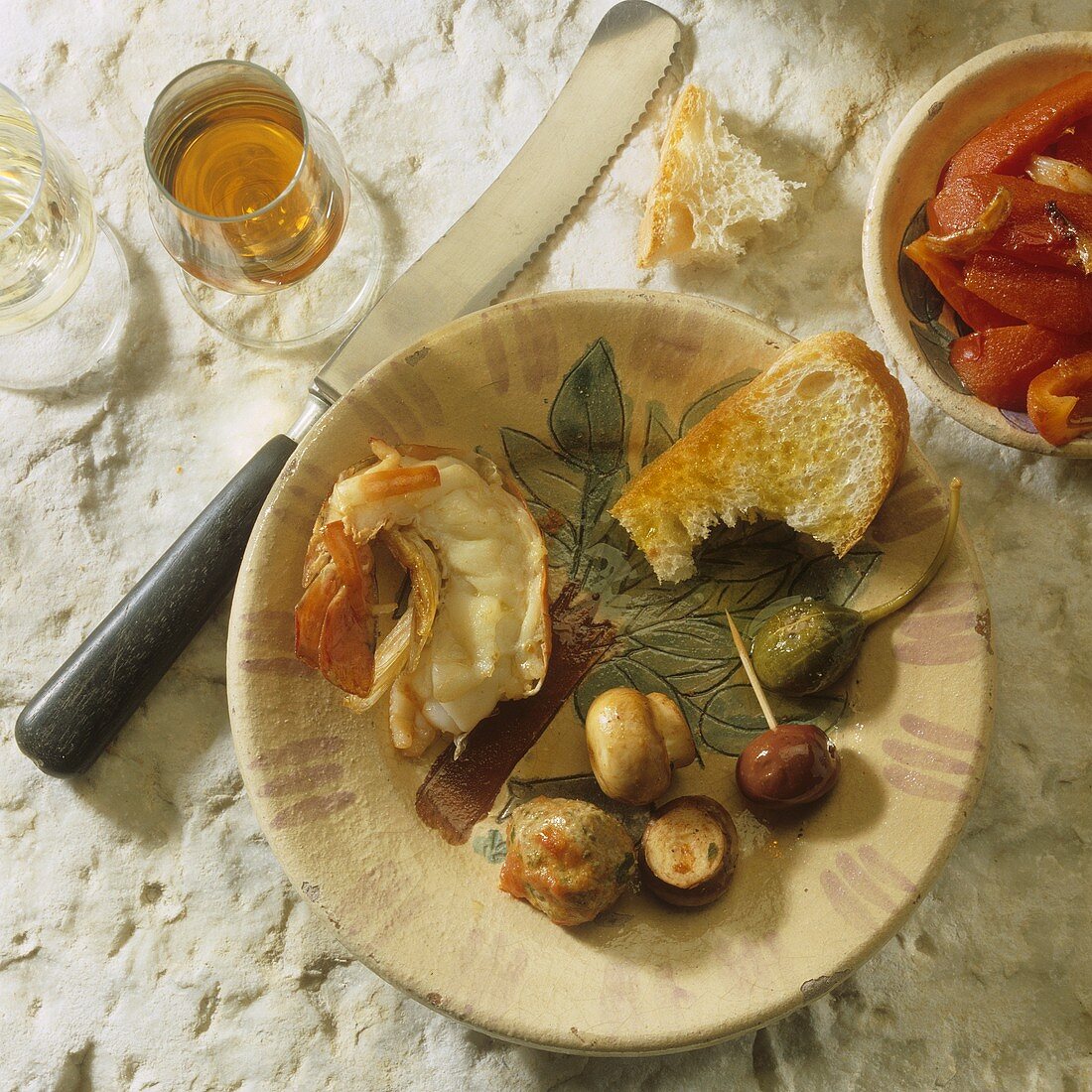 Spanish tapas: prawn, button mushrooms, olive and caper