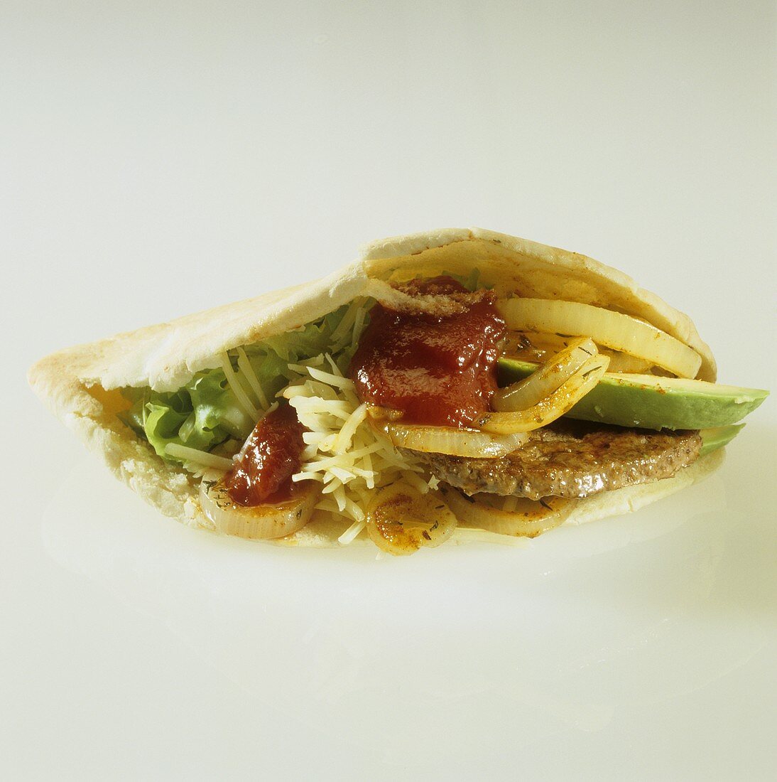 Taco filled with burger and avocado