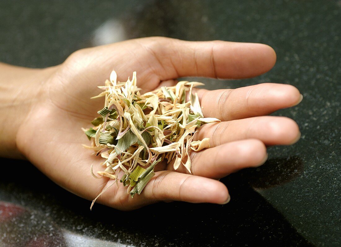 Hand holding dried lemon grass tea
