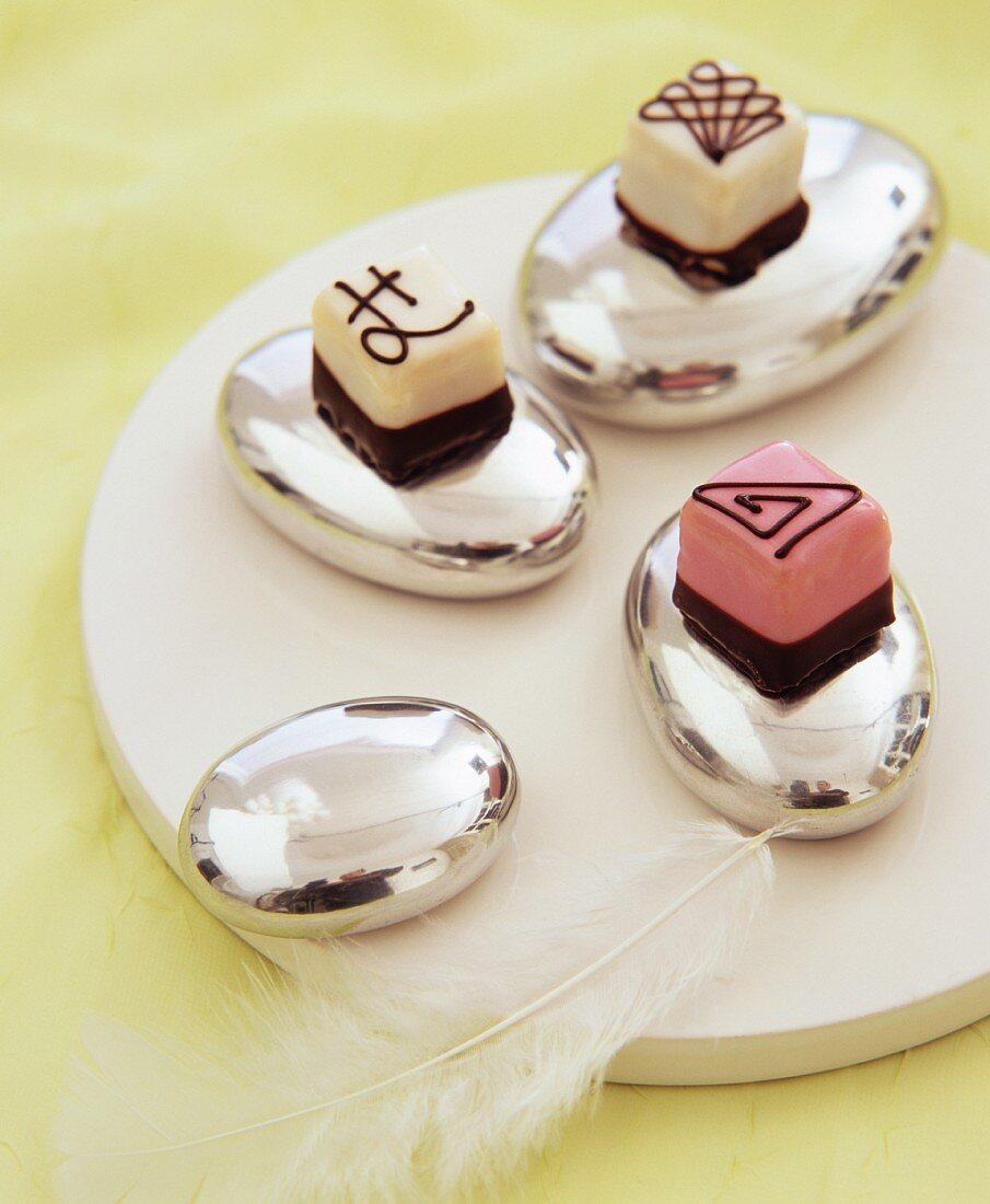 Three petit fours on silver eggs