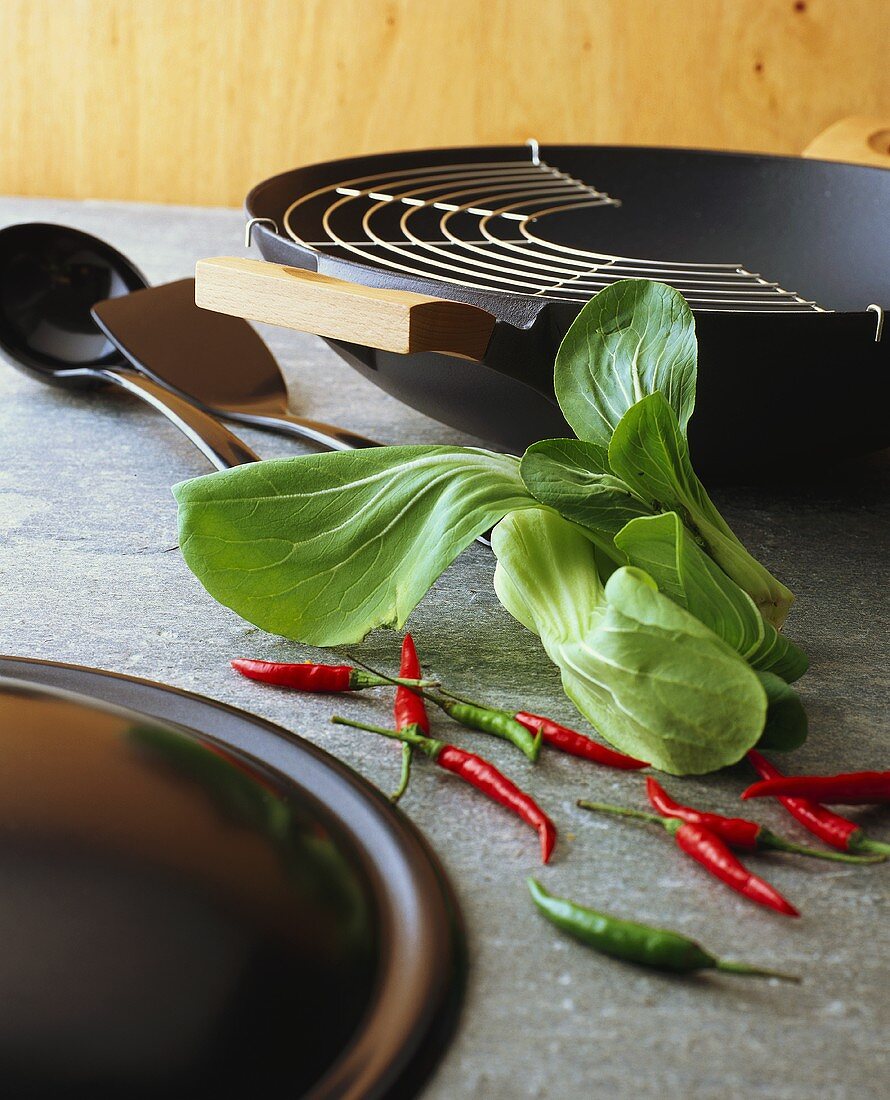 Wok with chili peppers and pak choi