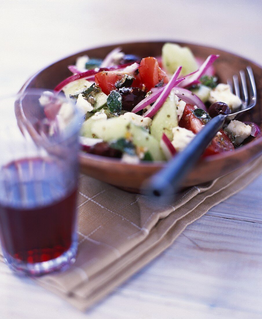 Greek salad with a glass of wine
