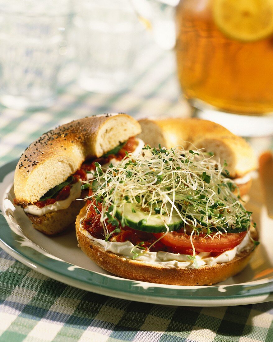 Bagels with tomatoes, soft cheese, cucumber and cress