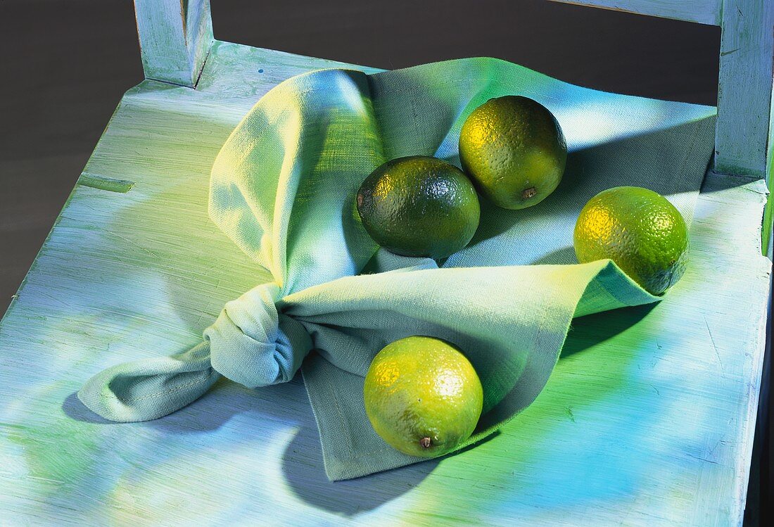 Four limes on a napkin