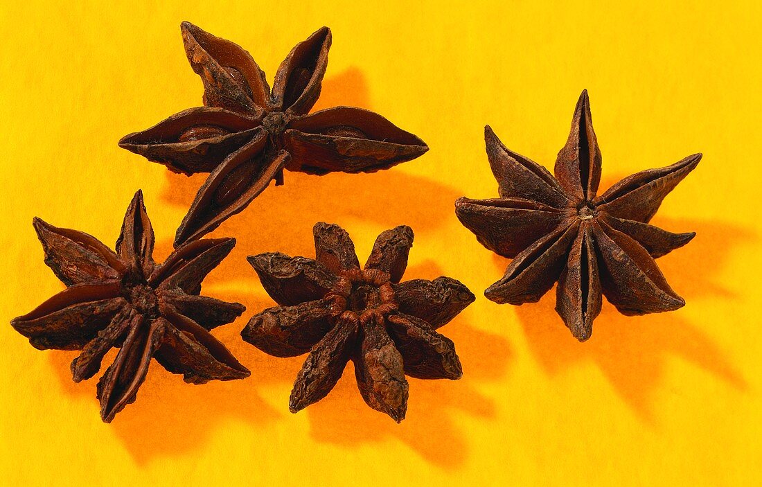 Four star anise on orange background
