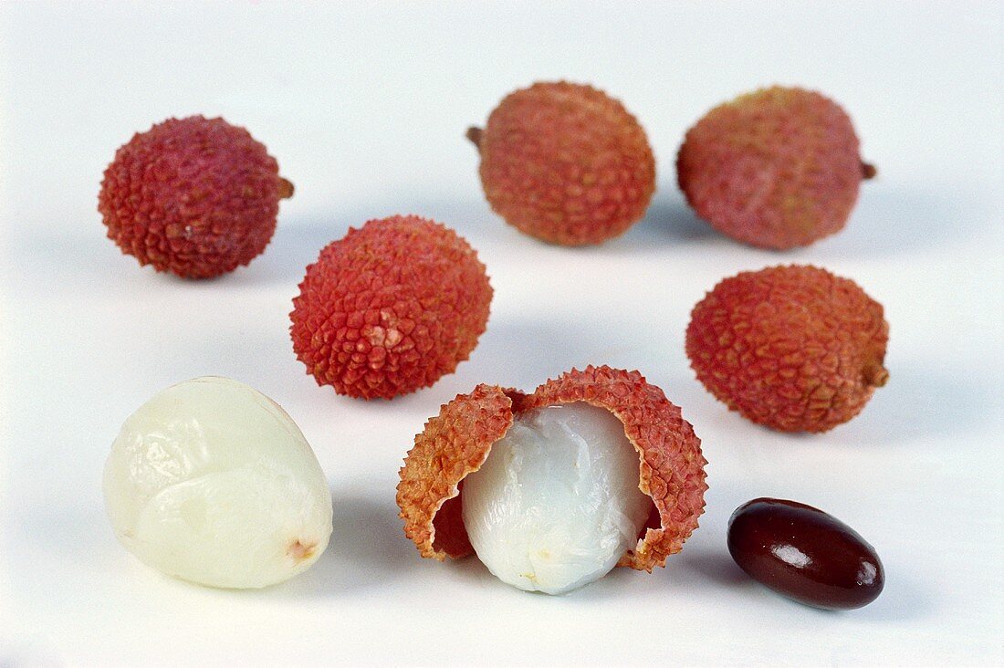 Several lychees on white background