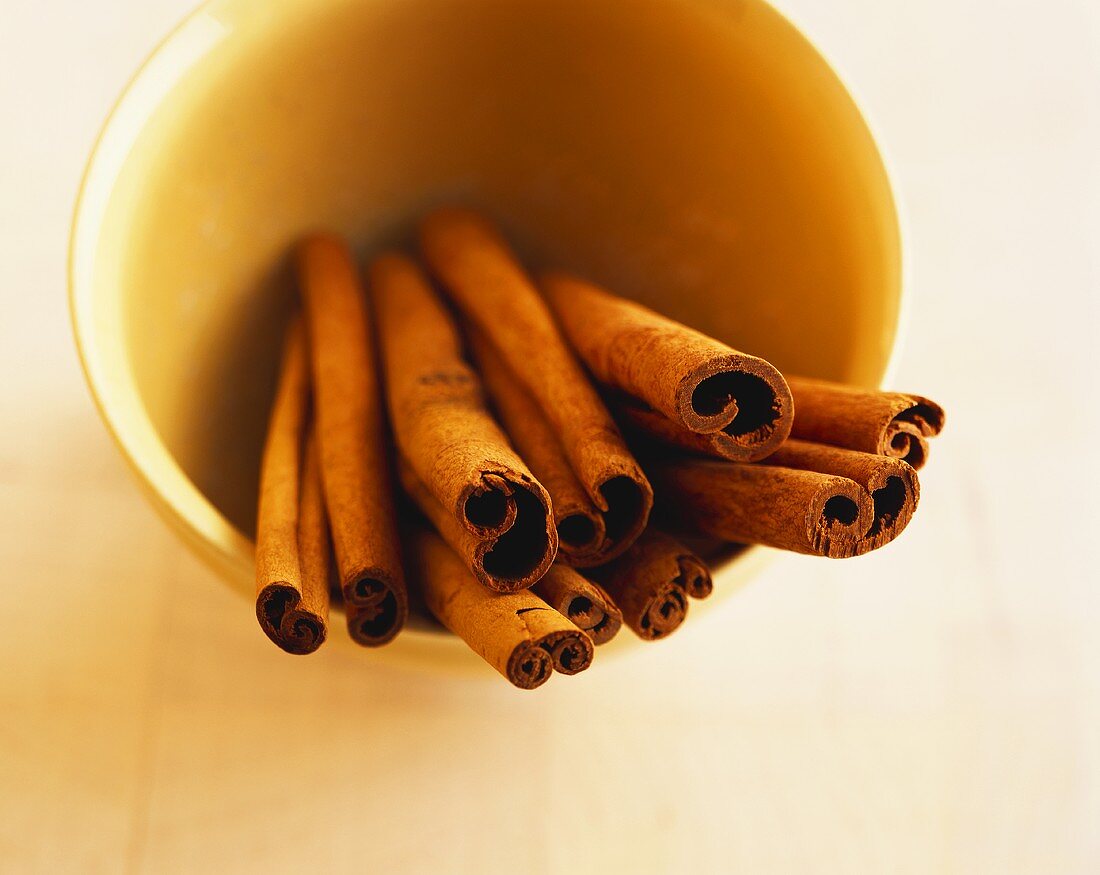 Several cinnamon sticks in a bowl