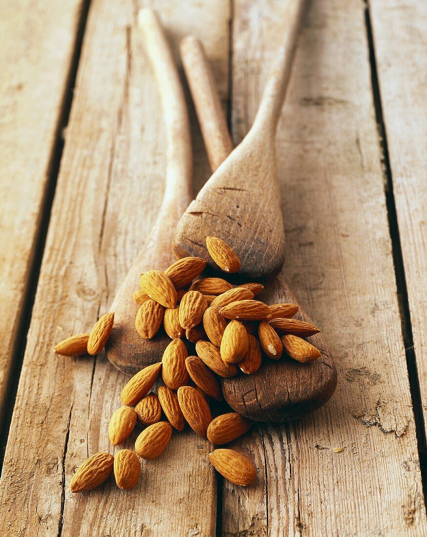 Almonds with old wooden spoons