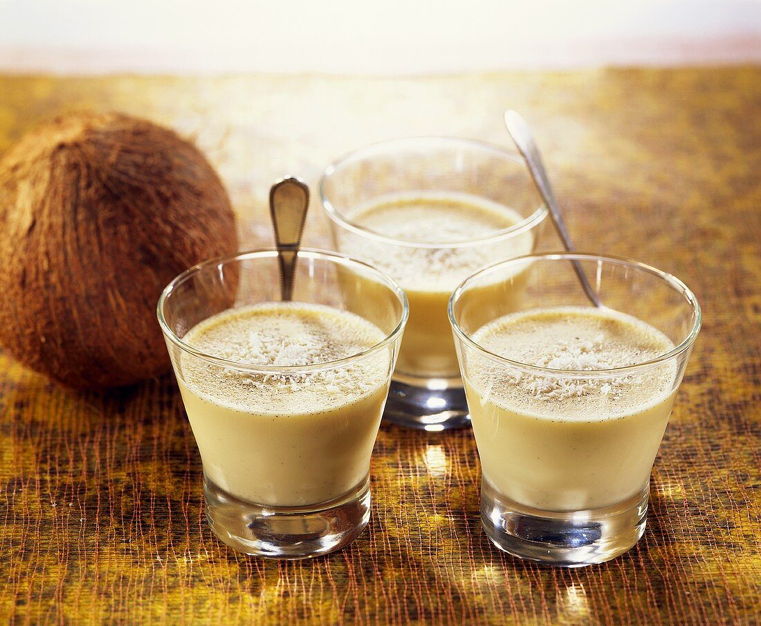 Coconut custard in three glasses with a coconut
