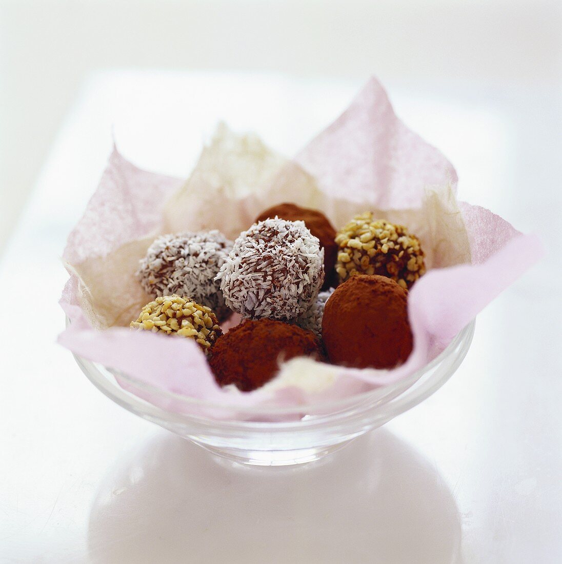 Several chocolate truffles in a small bowl