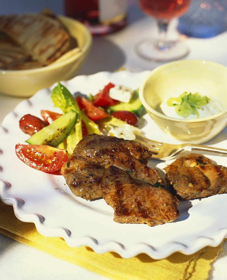 Barbecued pork steak with vegetable accompaniments