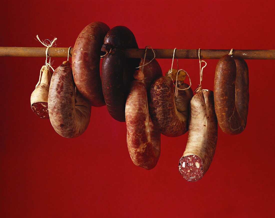 Several black puddings hanging on a pole