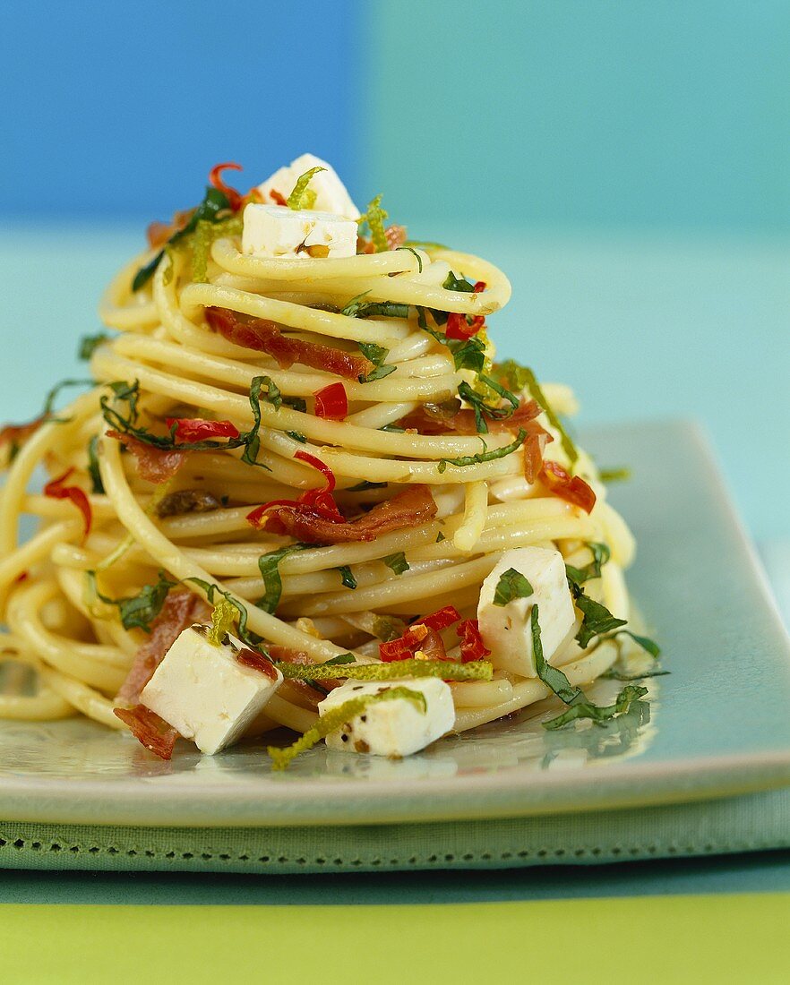 Spaghetti with feta, bacon, chili and basil