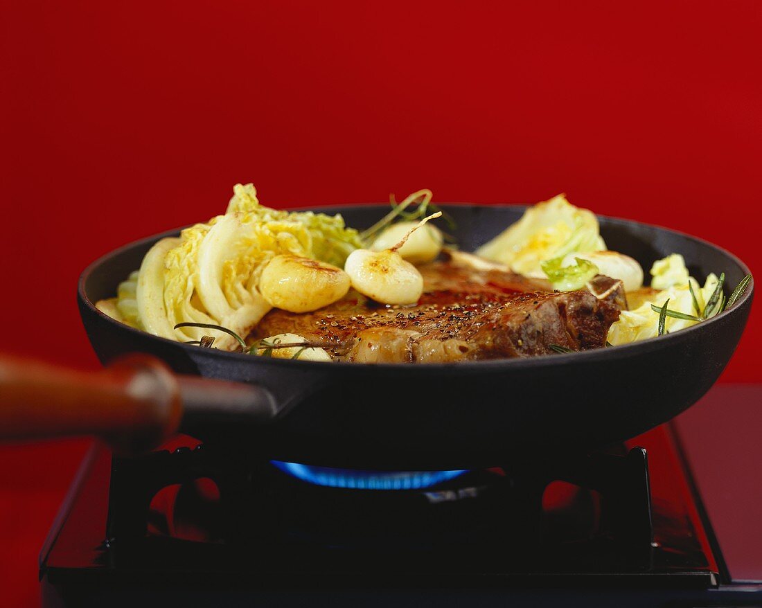 Porterhouse steak with cabbage in the frying pan