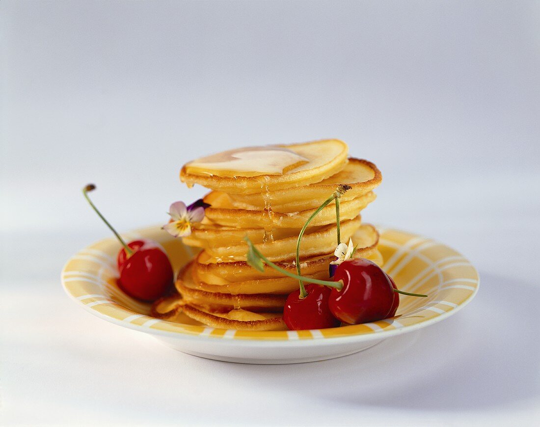 Lemon and ricotta pancakes with cherries and edible flowers
