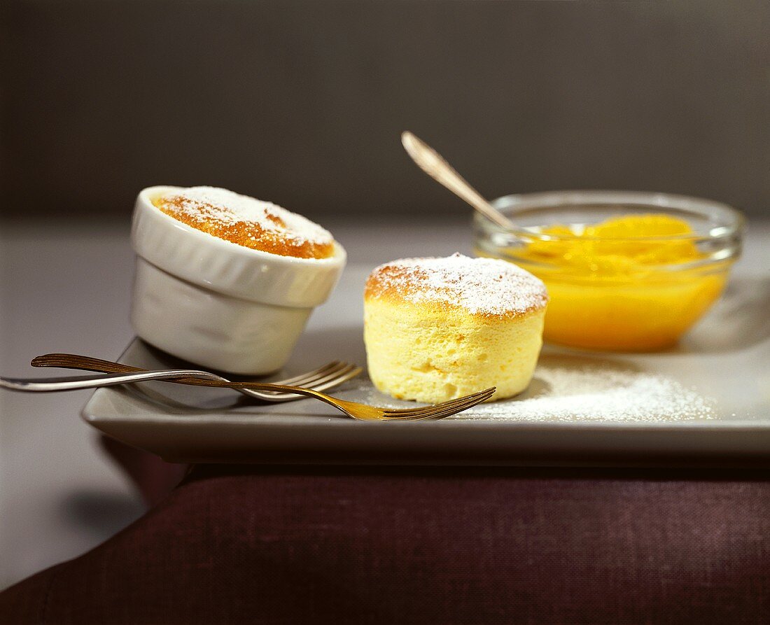 Two orange soufflés with preserved oranges