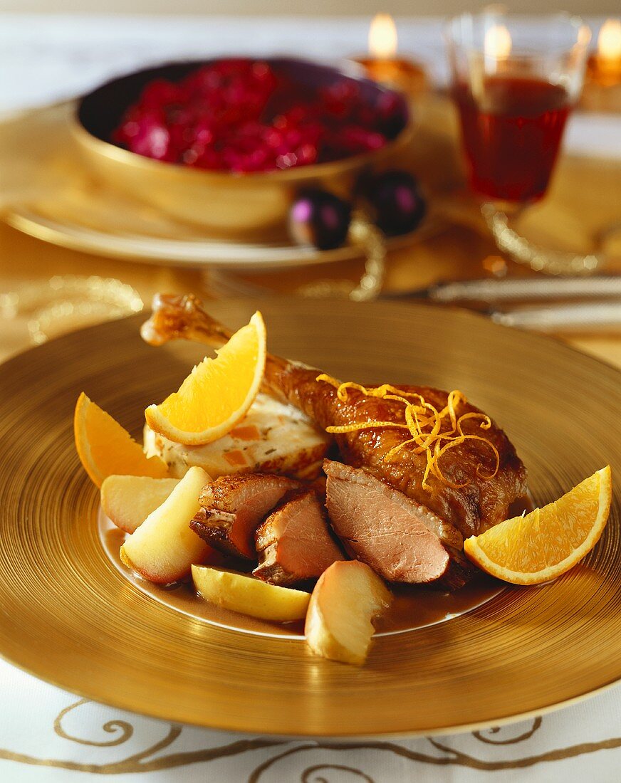 Goose leg with orange and apple wedges