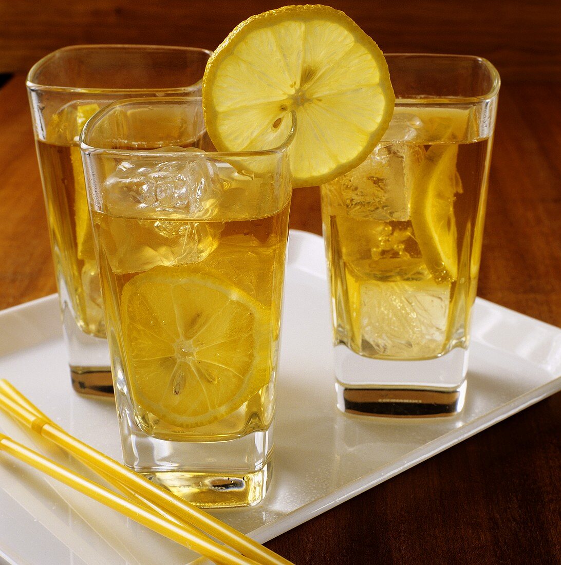 Three glasses of iced tea with slices of lemon
