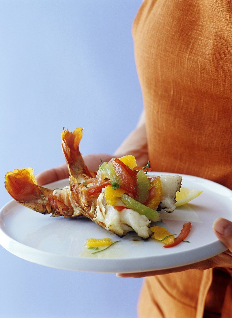 Woman holding barbecued lobster