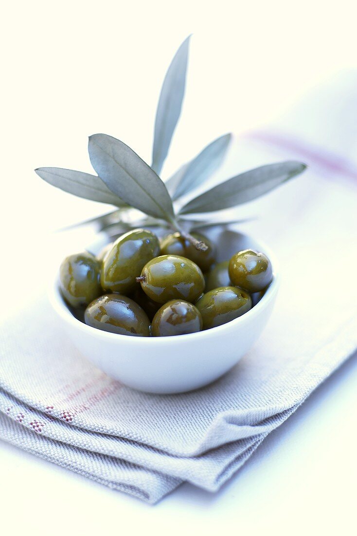 Green olives in a white bowl