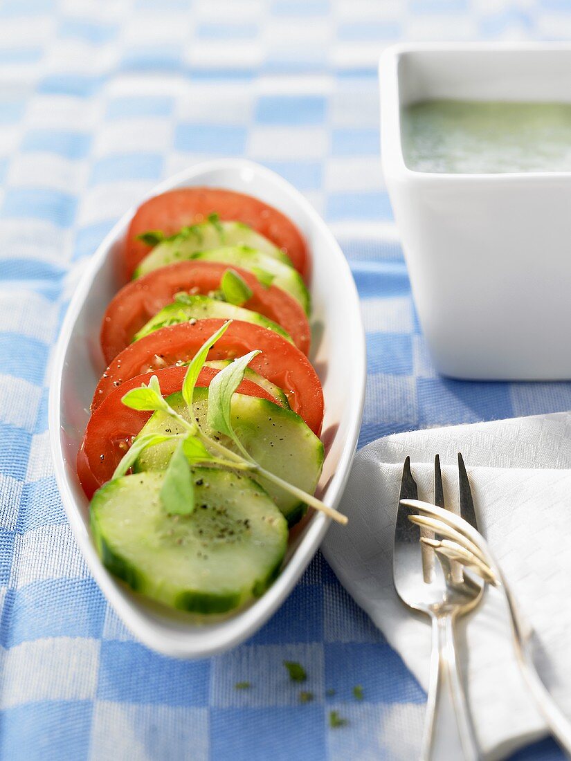 Cucumber and tomato salad in a boat-shaped dish