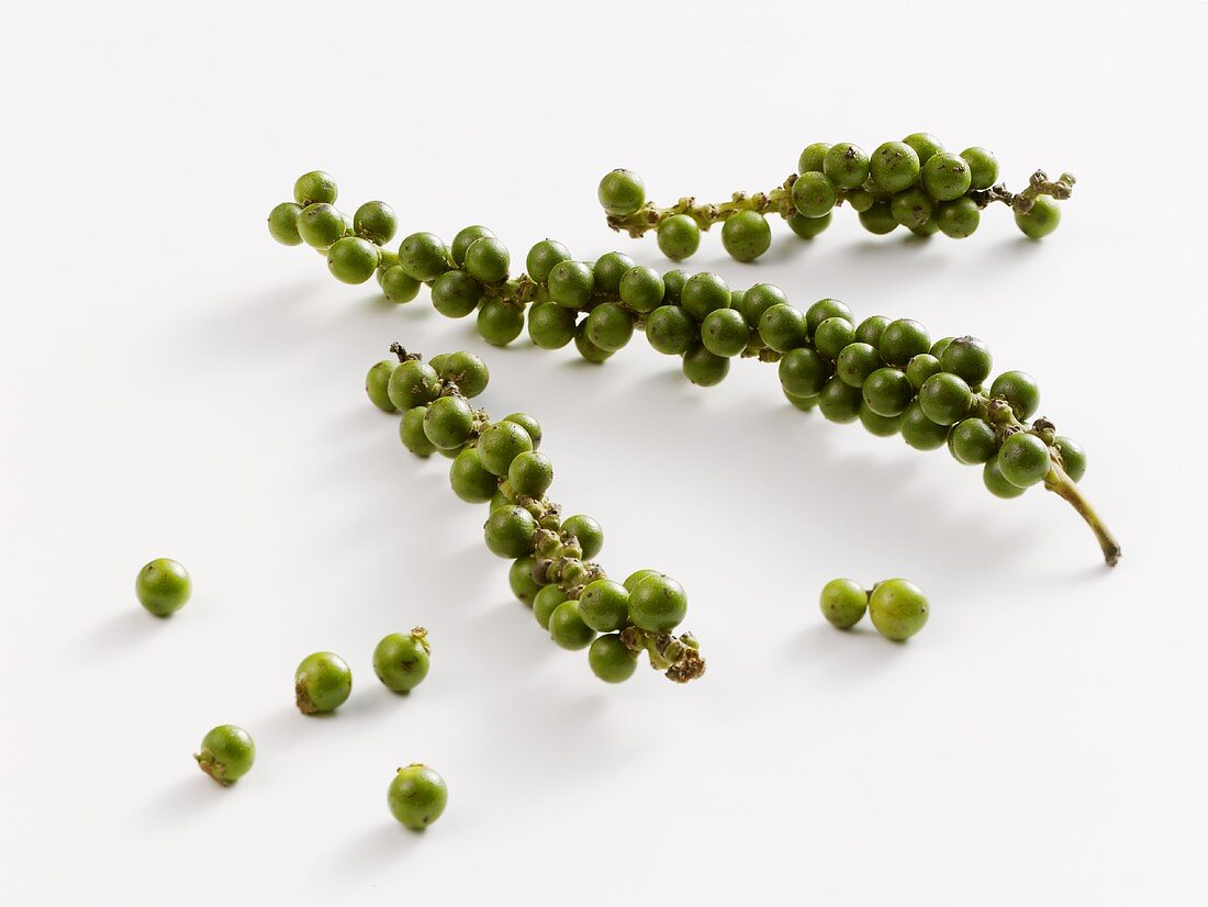 Bunches of green peppercorns
