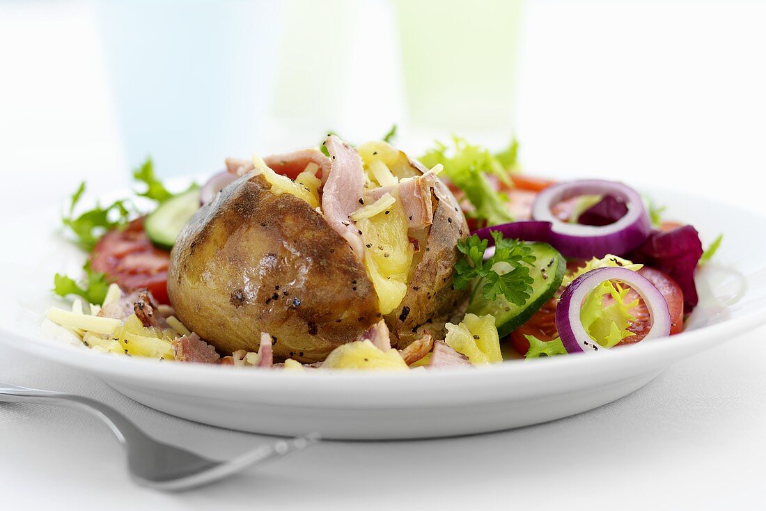 Baked potato with ham and salad